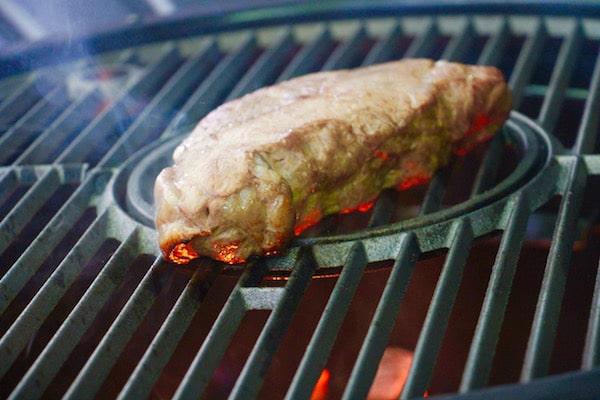 Steak being cooked on grill low heat. 