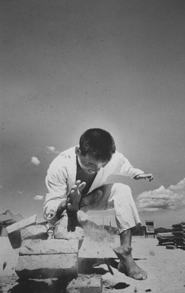 Chinese martial artist breaking concrete blocks. 