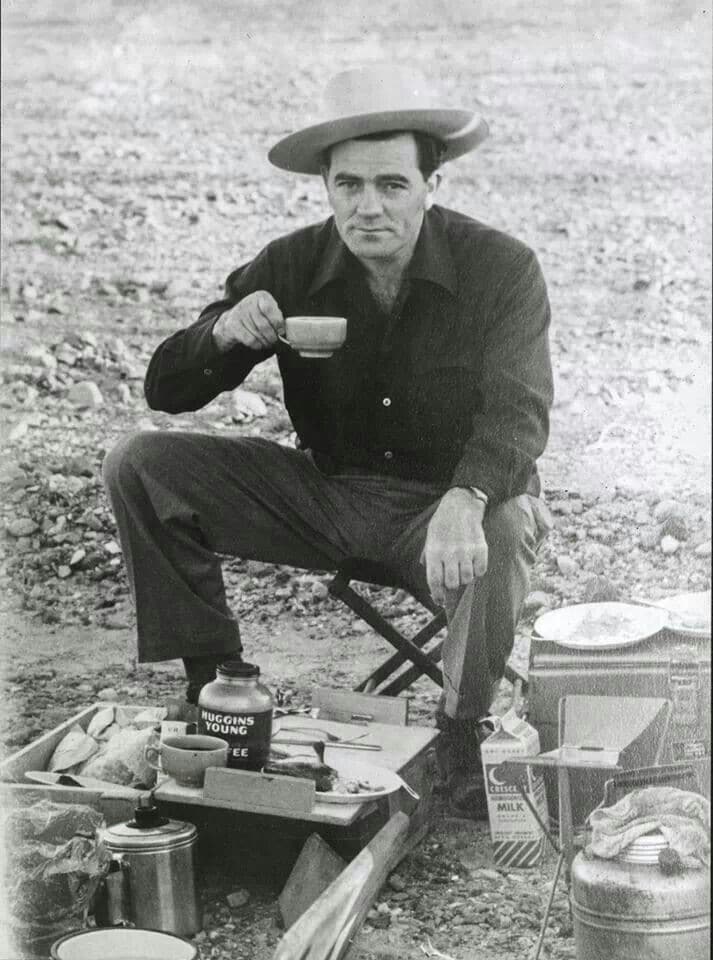 Louis l'amour camping drinking coffee outside. 