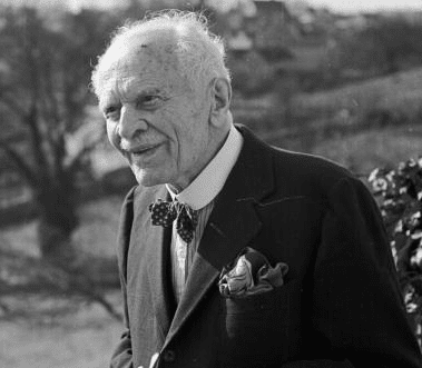 A black and white photo of a successful older man in a suit.