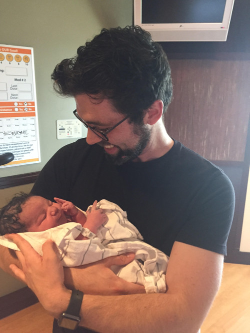 New adoptive parent holding infant son. 