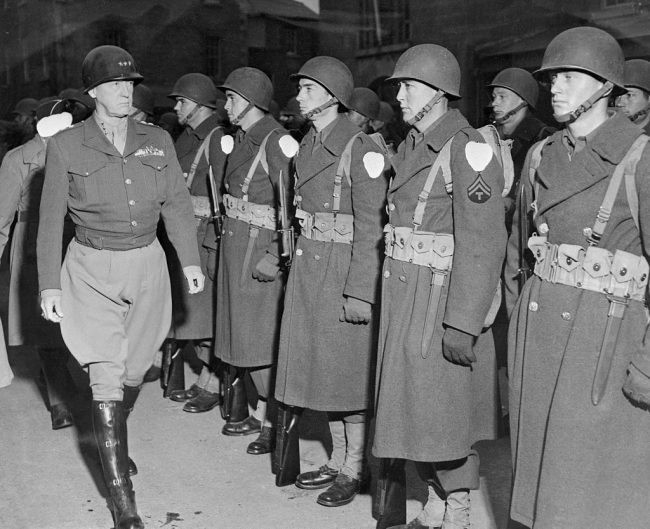 Patton inspecting line of soldiers. 