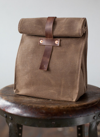 A manly brown lunch bag sits on a wooden stool.