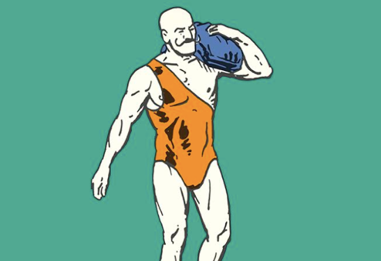 A man in a bathing suit carrying a heavy blue bag.