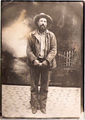 An old photograph of a man in a cowboy hat from the Wild West.