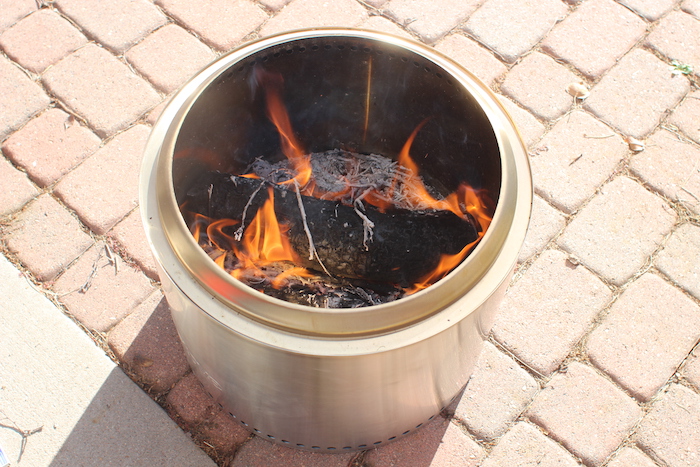 Solo stove bonfire with wood burning inside.