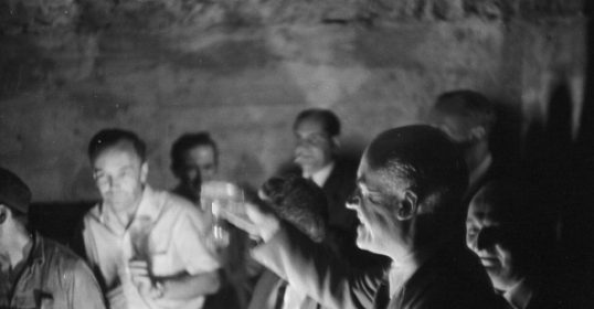 A group of people standing in a dark room.