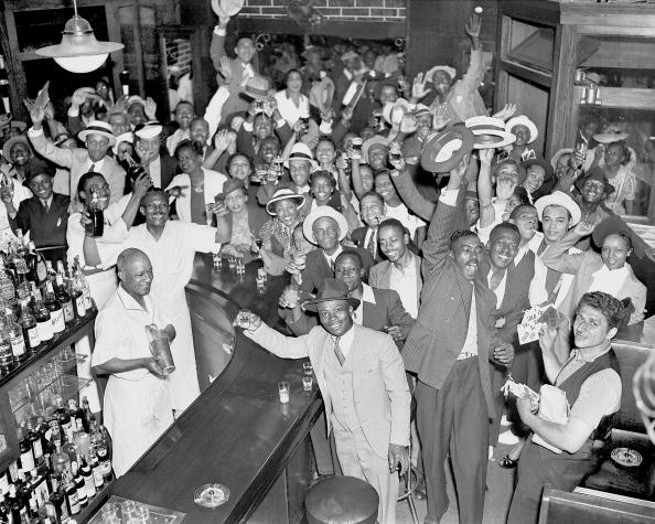 Large group of people giving toast in the vintage bar.