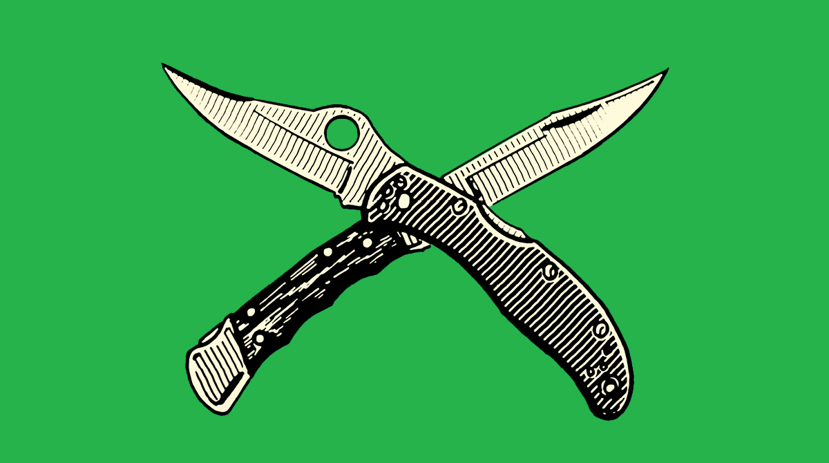 A pair of pocket knives on a green background.