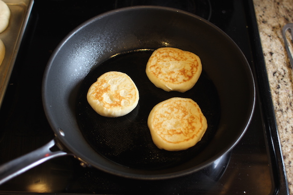 Cooked english muffins on skillet.