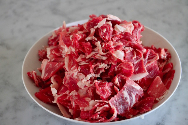 Shredded meat placed in a bowl.