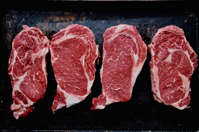 Thick and uncooked beefs steaks displayed.