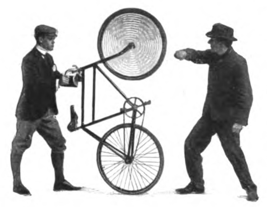 Vintage man lifting the front wheel of a bicycle in the air.