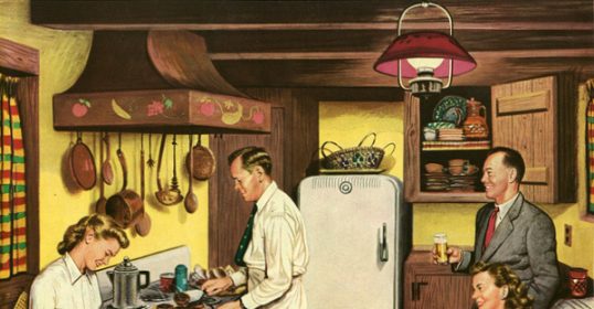 A gathering of people in a kitchen.