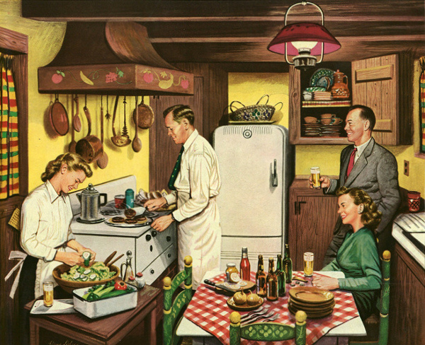 A gathering of people in a kitchen.