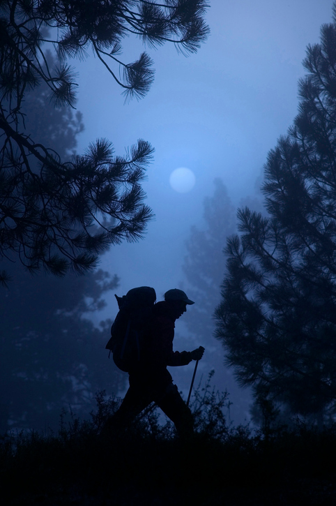 Man hiking on a mountain late at night. 