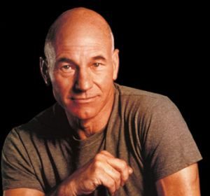 A bald man posing for a photo.