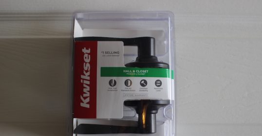 A plastic package with a black handle and a new green one.