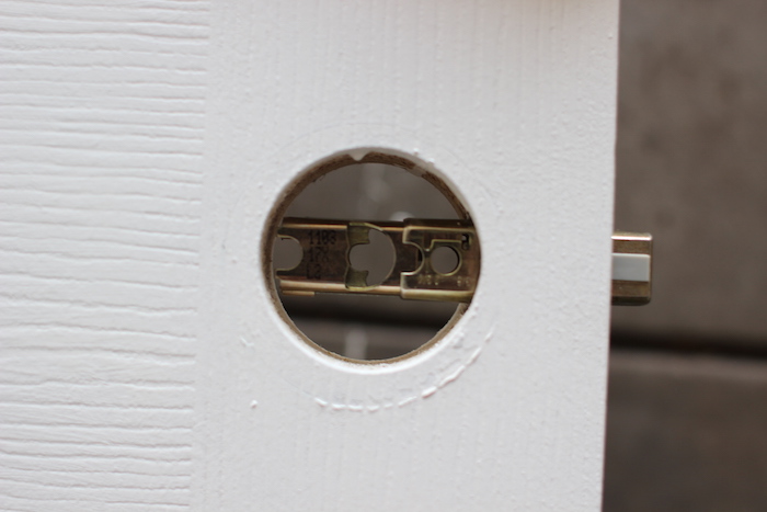 Front view of door knob's hole with latch unit in it.