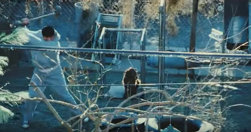 Rocky slamming the tire with a sledgehammer in snow.