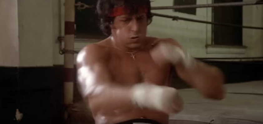 Rocky punching while doing sit-ups. 