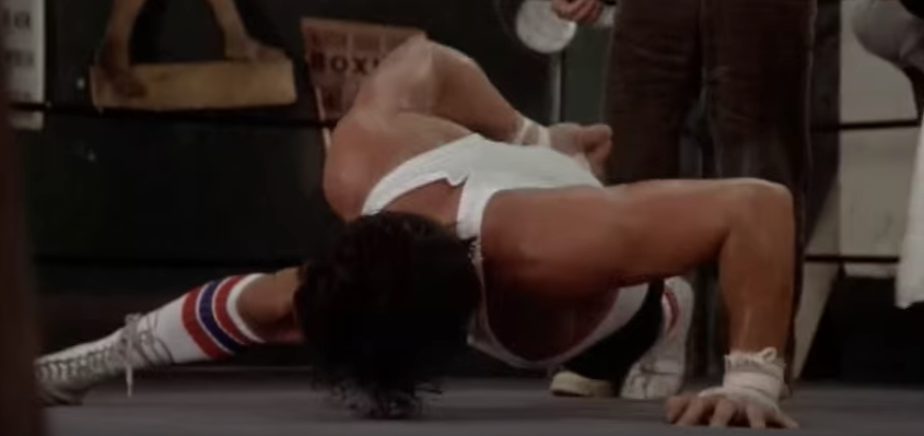 Rocky doing one arm push-ups.