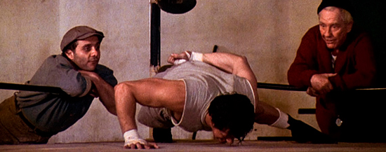 Rock doing alternating one-arm push-ups.