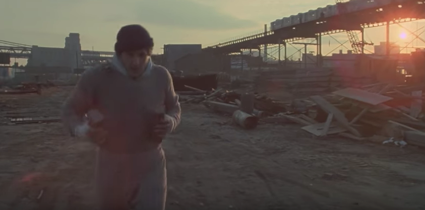 Rocky running with bricks in his hands.