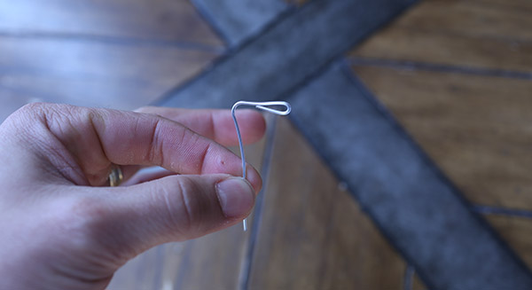 Straightened out paper clip and one end of it left bent.