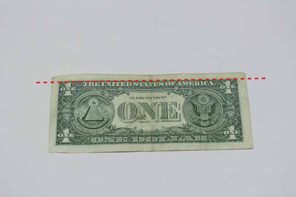 One American dollar with upper side marked.