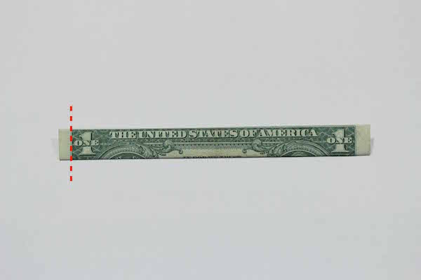 Folded one American dollar marked from one edge. 