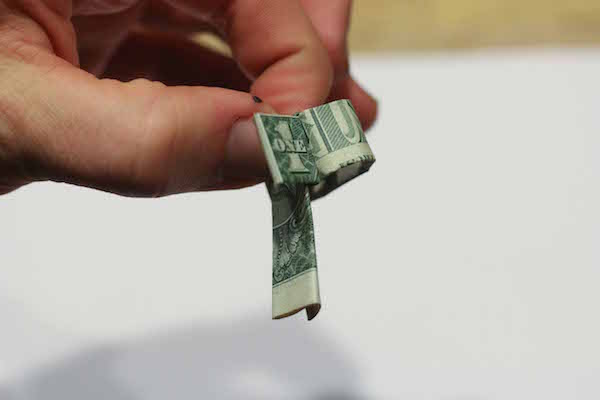 Vertical side of dollar bill displayed.