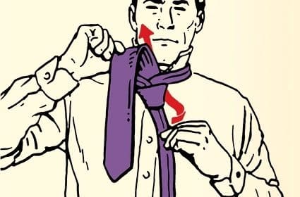A person in the process of learning how to tie a simple necktie knot.