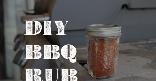 A jar of BBQ seasoning on a table.