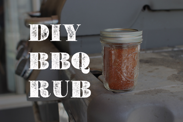 A jar of BBQ seasoning on a table.