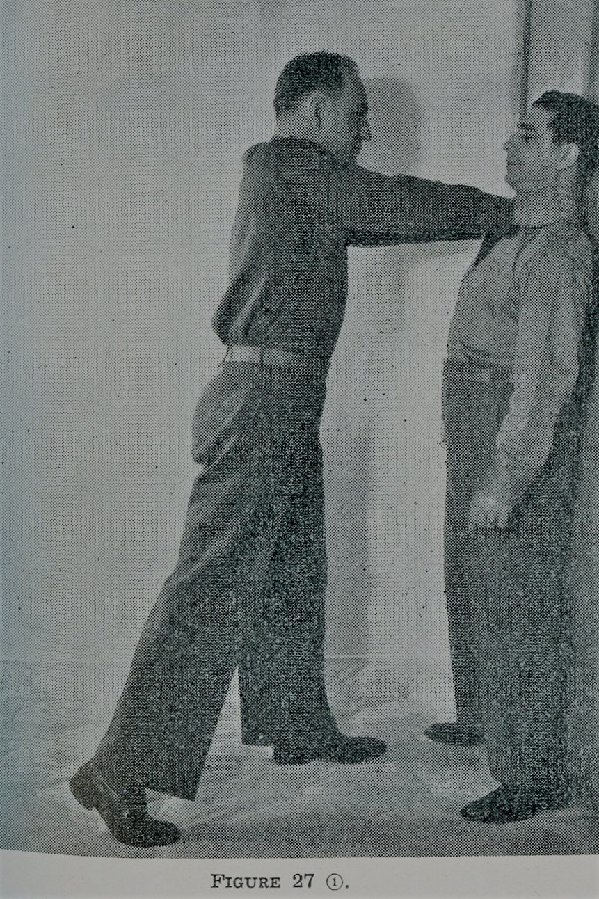 Two-handed front choke against a wall during self defense.