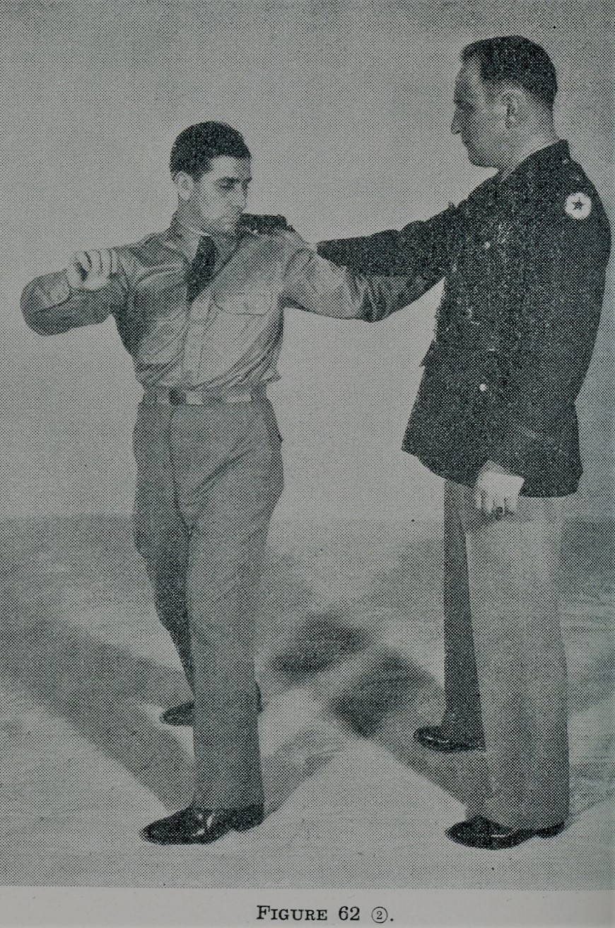 Grasping opponent's right elbow during self defense.