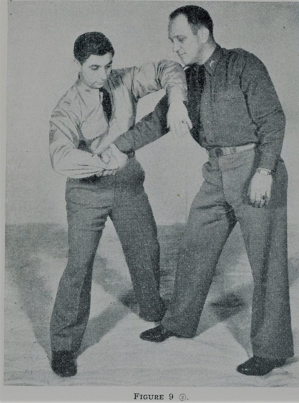 Man twisting the hand of the opponent for self defense.
