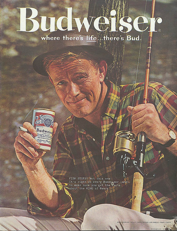 Vintage man holding Budweiser can and fishing rod in another hand.