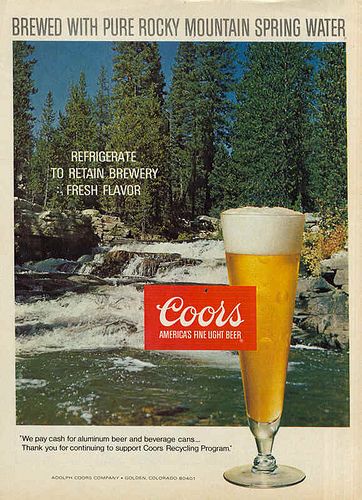 Vintage glass of Coors in glass and scenery in background.