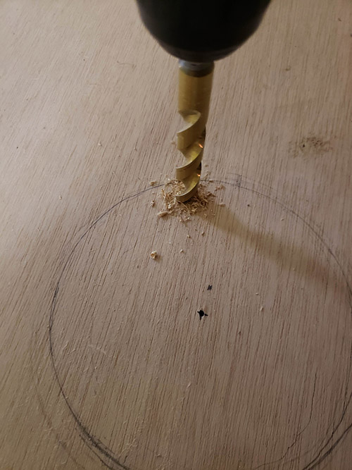 Making holes with drill machine on the marked circle. 