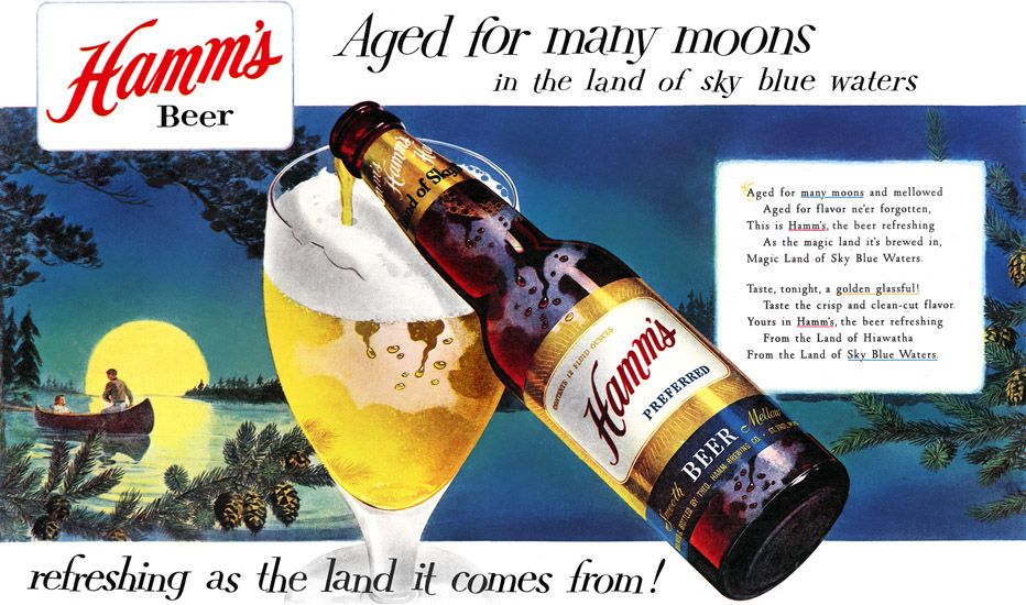 Bottle of Hamm's beer filling in a glass.