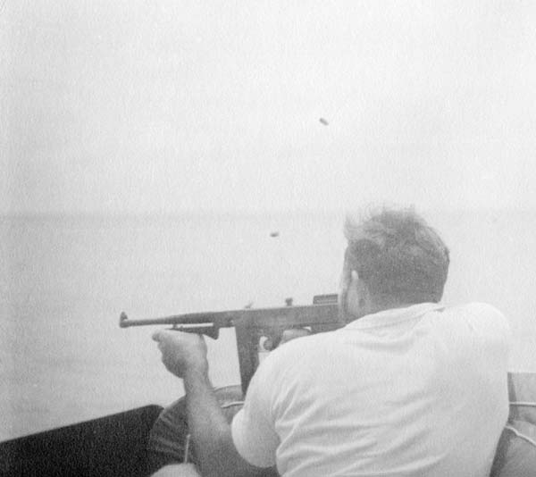 Hemingway pointing the machine gun.