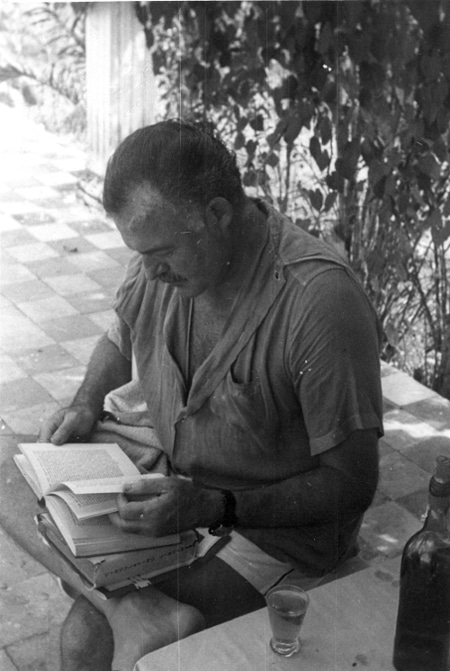 Hemingway reading book.