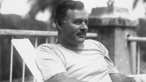 A black and white photo of a man sitting in a chair.