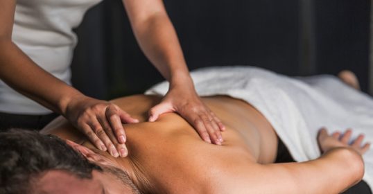 A man receiving a massage at a spa.