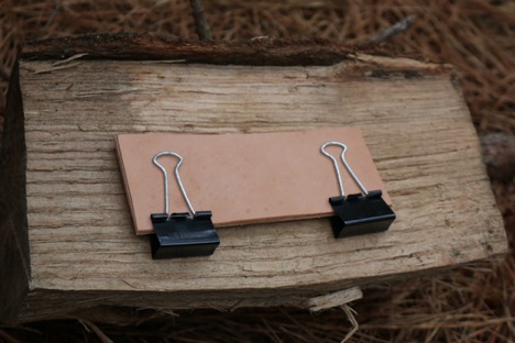 Holding leather in clips.