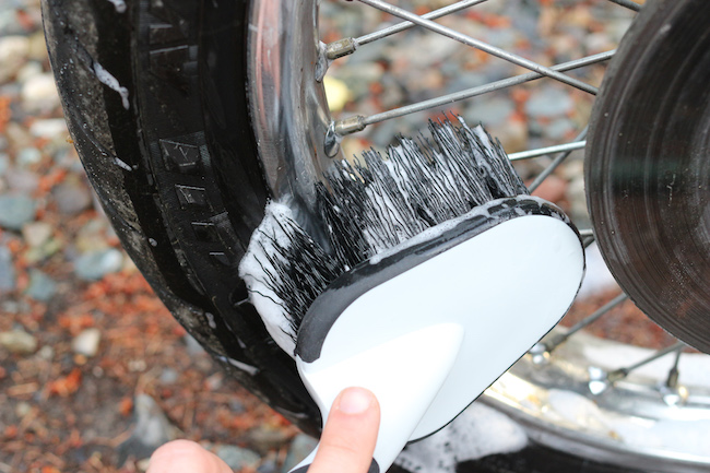Cleaning the tire with brushes.