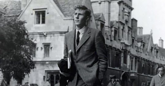 A successful man in a suit strolling down the street.