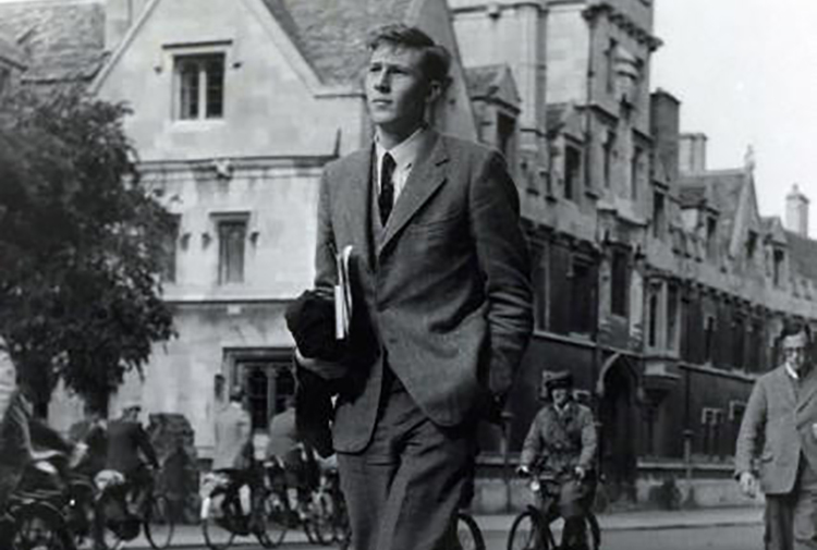 A successful man in a suit strolling down the street.